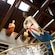 Figureheads adorn the interior walls of a building with thick wood beams in the ceiling